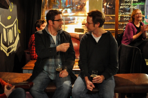 James Smith and Matt Kirkegaard chatting at a bar